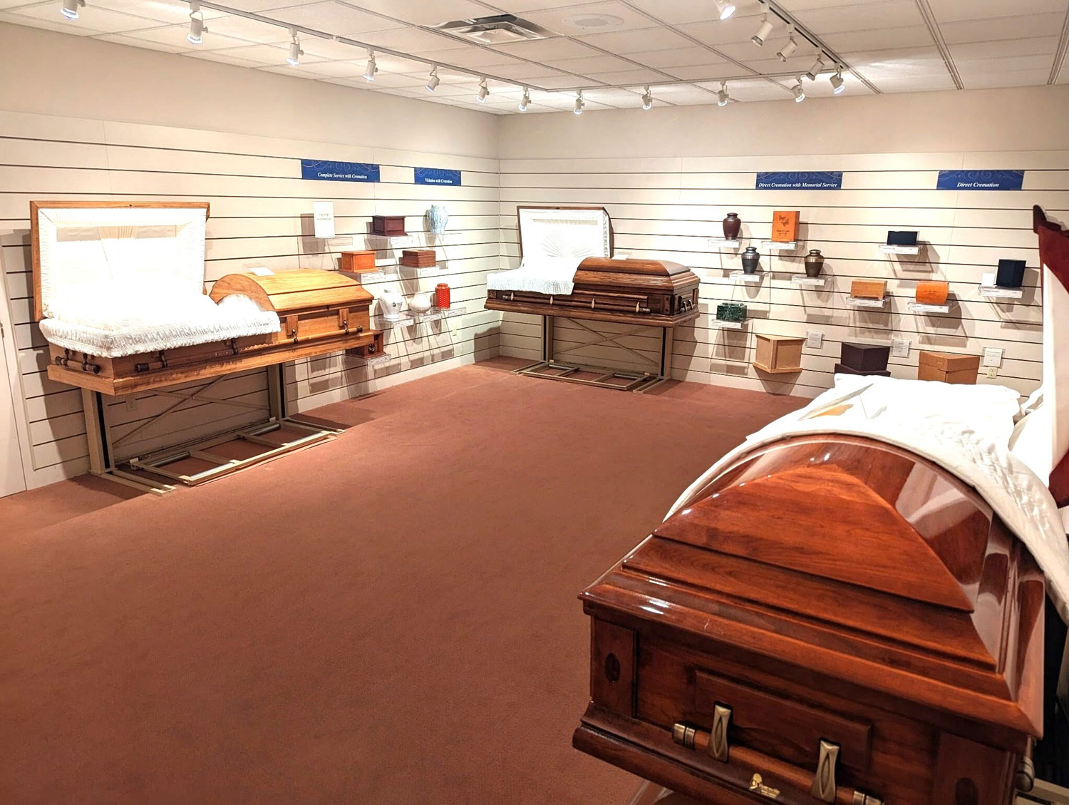 Cremation urns and few caskets on display in the urn room.